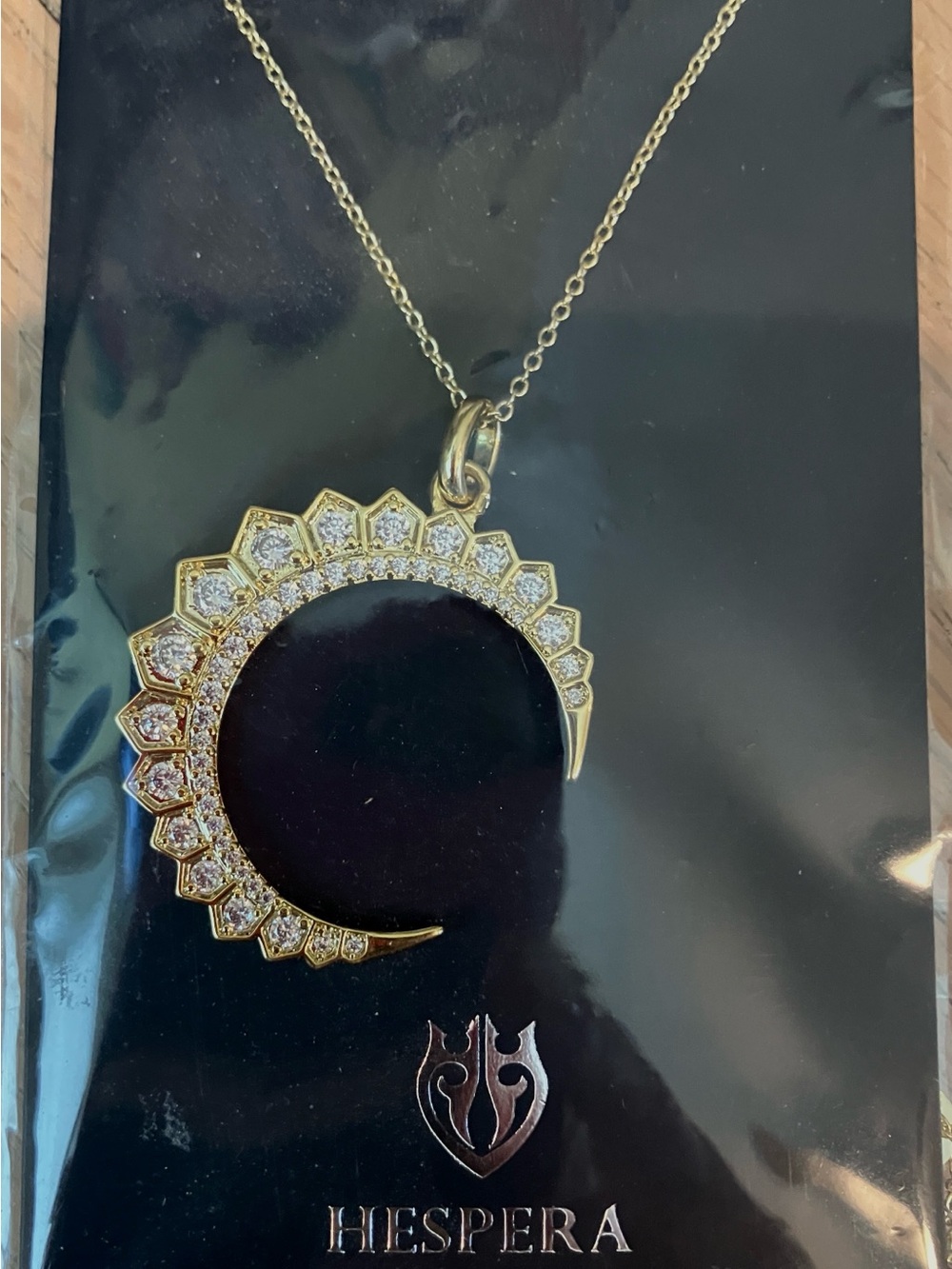 Hespera Gold-Tone Crescent Pendant Necklace with White Stones